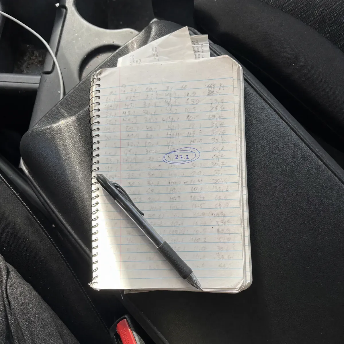 A reader's handwritten fuel log with 27.2 MPG circled